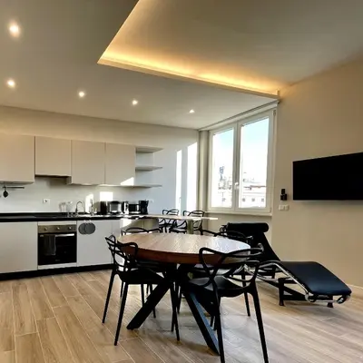 a kitchen and dining room with a table and chairs at Elements in Rome