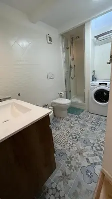 a bathroom with a sink and a washing machine at Testaccio Terrace,Perfect for families or small groups in Rome