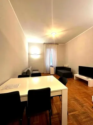 a living room with a white table and chairs at Cerri apartment in Rome