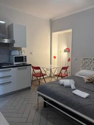 a kitchen and a bedroom with a bed and a table at Cerri apartment in Rome