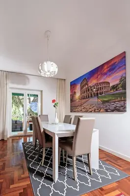 a dining room with a white table and chairs at E&L apt 150sqm 3BR Metro 30m Park in Rome