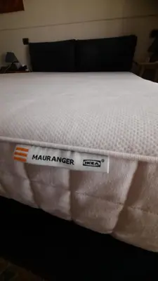 a white mattress with a mattress maker sign on it at Urban Welcome Metro Battistini in Rome
