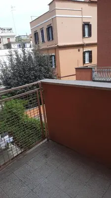 a balcony with a fence and a building at Urban Welcome Metro Battistini in Rome