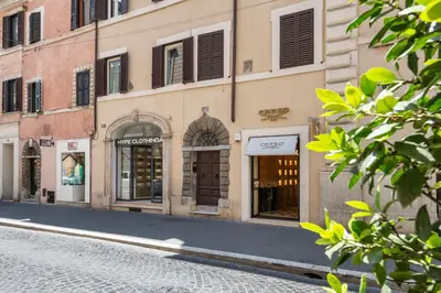 a cobblestone street in a city with stores at JSuite in Rome