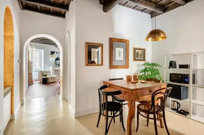 a kitchen and dining room with a wooden table and chairs at JSuite in Rome