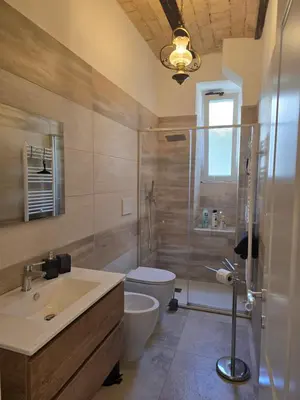 a bathroom with a sink and a toilet and a shower at Testaccio Charme Apt in Rome
