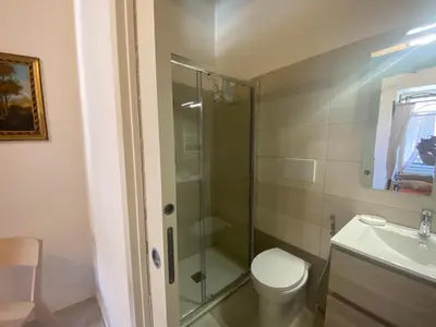 a bathroom with a shower and a toilet and a sink at Testaccio Charme Apt in Rome