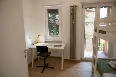 a bedroom with a desk with a chair and a bed at Fiqus in Rome