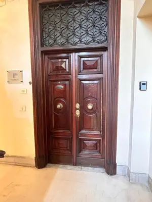 a large wooden door in a room with at DOMUS Laura VATICANO in Rome