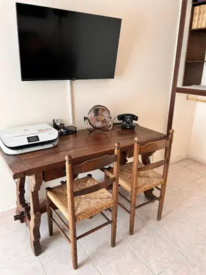 a wooden table with a television on a wall at DOMUS Laura VATICANO in Rome