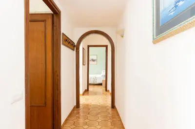 a hallway with an arched door and a bedroom at VIVA Rome Apartment 