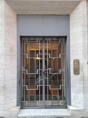 a window with metal bars on a building at Casa Lilli in Rome