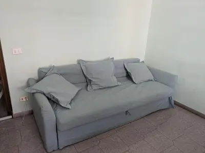 a couch in a room with pillows on it at Torpigna house in Rome