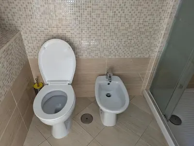 a bathroom with a toilet and a bidet at Torpigna house in Rome