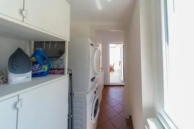 a kitchen with a washer and dryer in it at Cardinal Mistrangelo - next to the metro station, large and comfortable penthouse with terrace in Rome