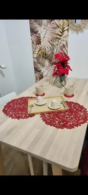 a white table with red flowers on top of it at Simone's apartment in Rome