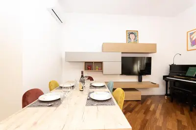 a dining room with a table and a piano at Barca House in Rome