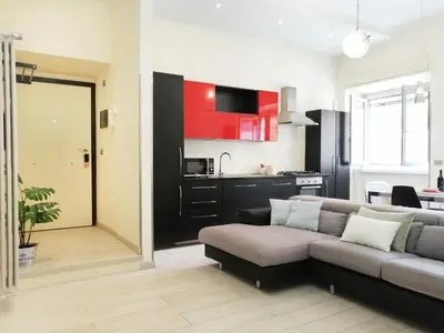 a living room with a couch and a kitchen at Appiano Vatican city, lovely apartment, 2 room ,Wi-fi 250 mbps in Rome