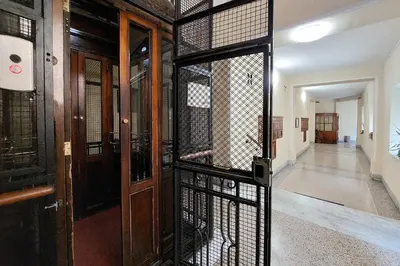 an open door to a cage in a building at 4BNB - Vittorio Emanuele Apartment in Rome