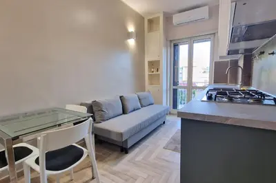 a kitchen and living room with a couch and a table at Vatican 6th floor Suite AC Panoramic views in Rome