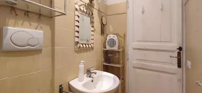 a bathroom with a sink and a white door at Trasteverino in Rome