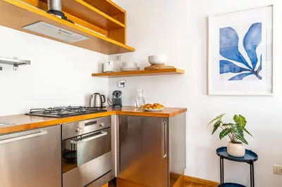 a kitchen with a stainless steel stove top oven at iFlat Discovering Monti - Charming and Modern apt in Rome