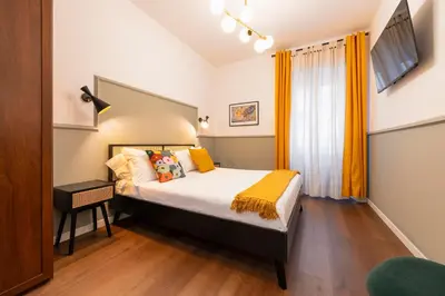 a bedroom with a bed and a television in it at Roomeasy Vatican Apartment in Rome