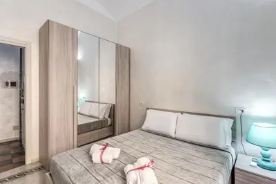 a bedroom with a bed with two towels on it at Casa Mecenate in Rome