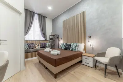 a bedroom with a bed and a chair and a window at Bello Urban Boutique - Golden Keys Collection in Rome
