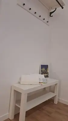 a white table in a room with a white wall at Domus Provinciae in Rome