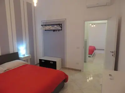 a bedroom with a red bed and a mirror at Apt Central Magenta in Rome