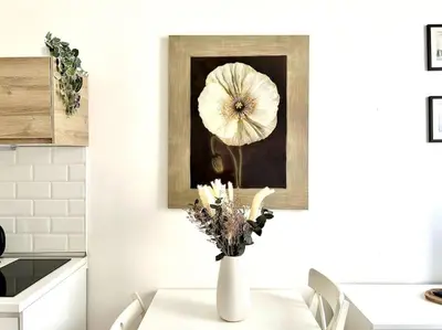a white vase with a flower on a table in a kitchen at Camilla Charme in Rome