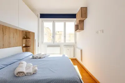 two beds in a bedroom with towels on them at Metro San Paolo -Capitol Haus Roma- Cozy Apartment in Rome