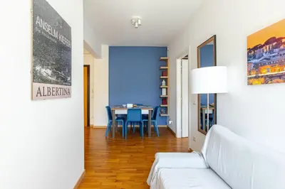 a living room with a white couch and a table at Metro San Paolo -Capitol Haus Roma- Cozy Apartment in Rome