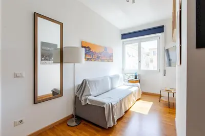 a living room with a couch and a mirror at Metro San Paolo -Capitol Haus Roma- Cozy Apartment in Rome