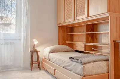 a bedroom with a wooden bunk bed with a lamp at Roma Monteverde Apartment in Rome