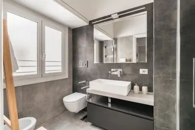 a bathroom with a sink and a toilet at Elegant Hideaway Steps from St Peter in Rome