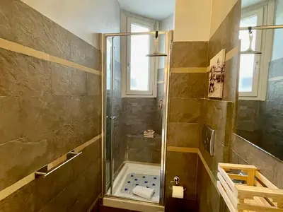 a shower with a glass door in a bathroom at Domus Laterani by JFM - Comfortable apartment big terrace Colosseo in Rome