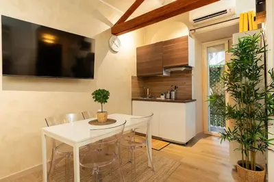 a kitchen with a white dining room table and chairs at Domus Romana Musei Vaticani in Rome