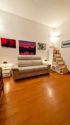 a living room with a couch and a staircase at Cozy Home in San Cosimato in Rome