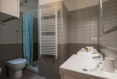 a bathroom with a sink and a toilet at Cozy apartment in Esquilino in Rome