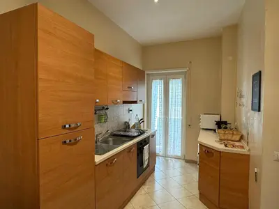 a kitchen with wooden cabinets and a sink at Hidden Gem in Magliana in Rome