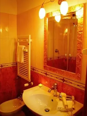 a bathroom with a sink and a mirror at Alla Basilica Rooms in Rome