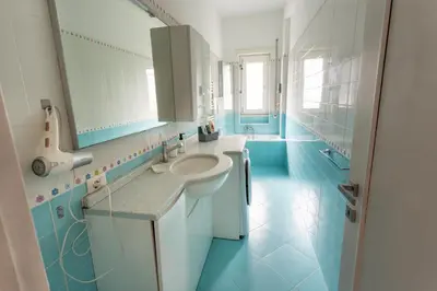 a blue and white bathroom with a sink and a mirror at 