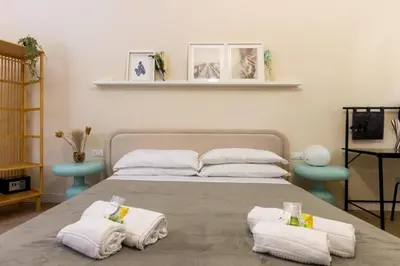a bedroom with a bed with towels on it at Aureum Angelicum in Rome