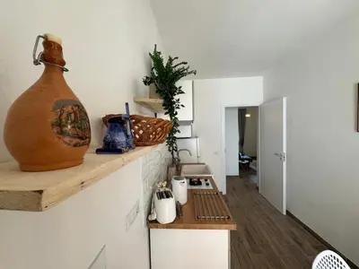 a kitchen with a large vase sitting on a shelf at Apt with balcony in Roman Quiet in Rome