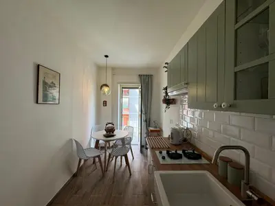 a kitchen with a sink and a table with chairs at Apt with balcony in Roman Quiet in Rome