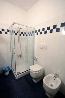 a bathroom with a shower and a toilet and a sink at We Love It - BestBnB Garbatella in Rome