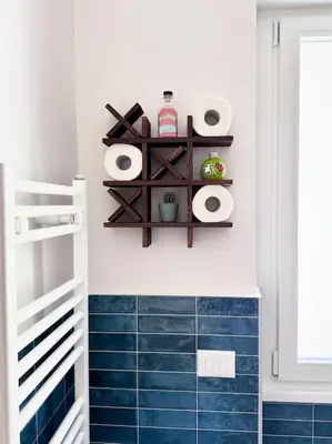 a bathroom with a blue tiled floor and shelves at La Casa di Casa - il tuo posto speciale in Rome