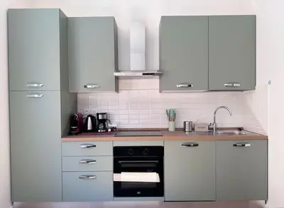 a kitchen with white cabinets and a sink at La Casa di Casa - il tuo posto speciale in Rome